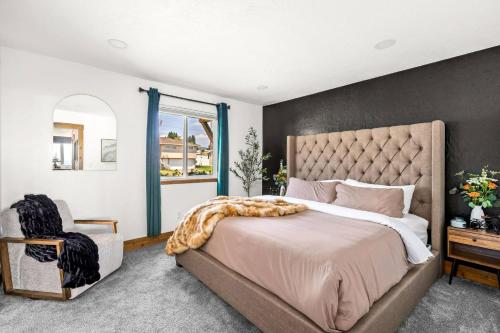 una camera da letto con un letto grande e una sedia di Great Falls Premier Retreat by Wrecked & Refined Stunning Views Hot Tub Family Fun a Great Falls