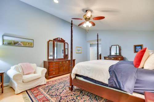 a bedroom with a bed and a chair and a ceiling fan at 4 Mi to UGA Pet-Friendly Home in Athens in Athens