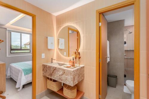 a bathroom with a sink and a mirror at Eco Resort Praia dos Carneiros Apt Luxo Beira Mar in Praia dos Carneiros