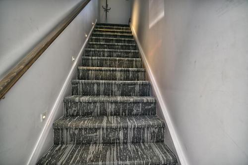a flight of stairs in a building at Downtown Sherby - Central, Parking, King Bed, Sleeps 3 in Sherbrooke