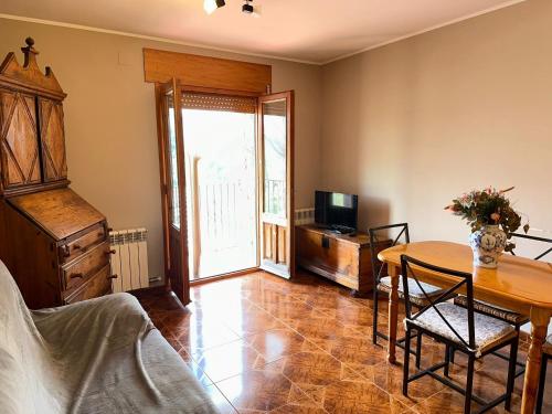a living room with a table and a television at Casa Costa Laspaúles in Laspaúles
