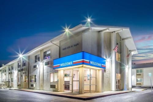 a front view of a hotel at night at Studio 6 Seattle, WA Sea Tac Airport South in SeaTac