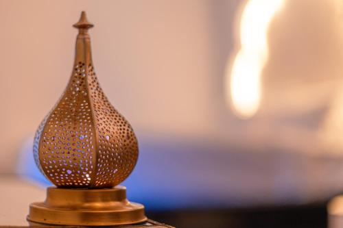 a brown glass vase sitting on a table at Riad L'ECOLE in Marrakech
