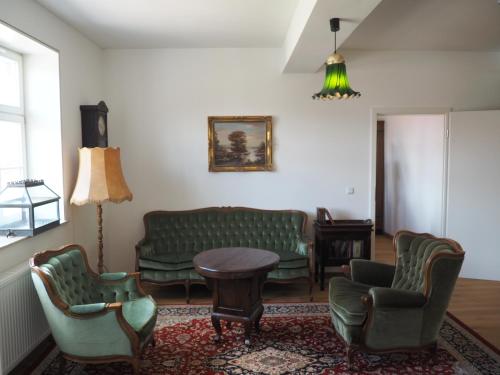 a living room with couches and a table and chairs at Rittergut Thürungen in Kelbra