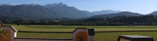a view of a field with mountains in the background at Appartements Panorama Schlössl in Velden am Wörthersee
