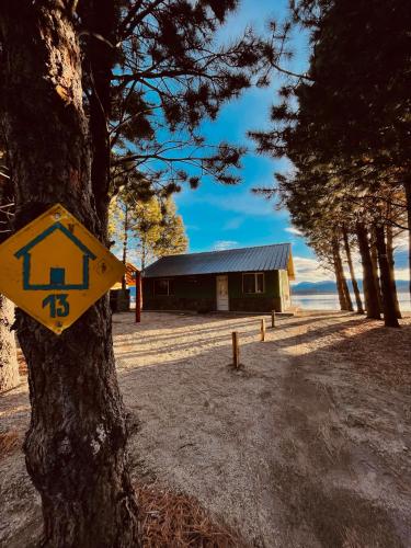 a yellow sign on a tree in front of a building at Complejo Don Cirilo in Villa Pehuenia