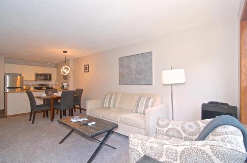 a living room with a couch and a table at Aspens on the Mountain Ski In Out in Whistler