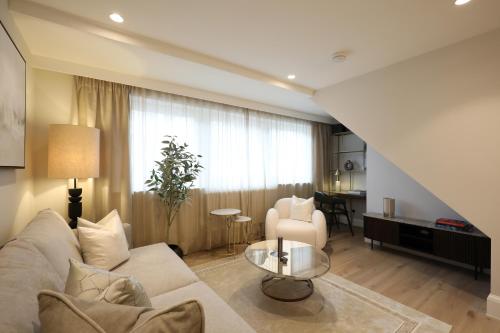 a living room with a couch and a table at Comfort 3 Bedroom Home in Notting Hill in London