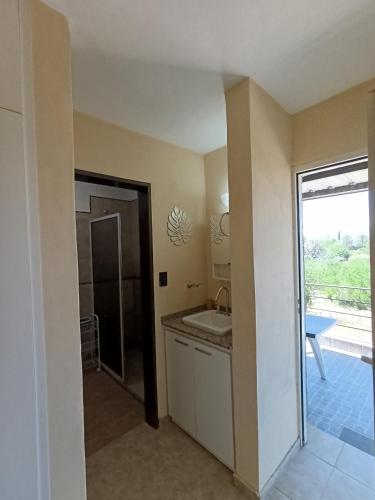 a bathroom with a sink and a shower at Complejo Refugio Playa Perelli in Villa Carlos Paz