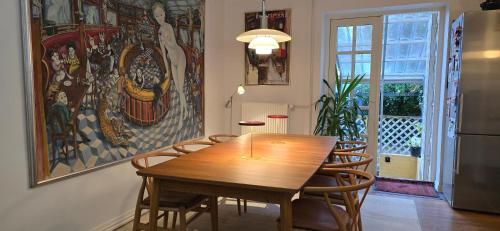 a dining room with a wooden table and chairs at Townhouse in the Center Free Parking in Aalborg