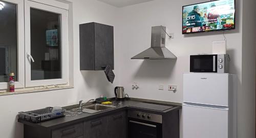 a kitchen with a white refrigerator and a sink at Lovely room near Balluta Bay RB in San Ġwann
