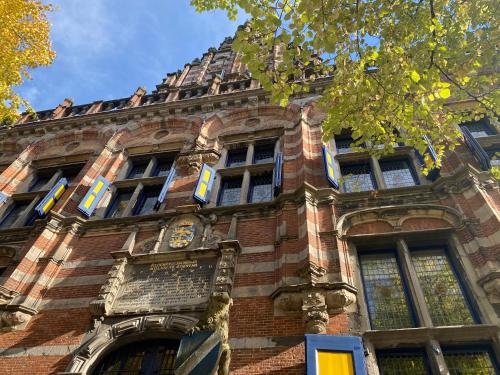 a building with a clock on the side of it at Vintage appartement in Pakhuis Friesland in centrum in Leeuwarden