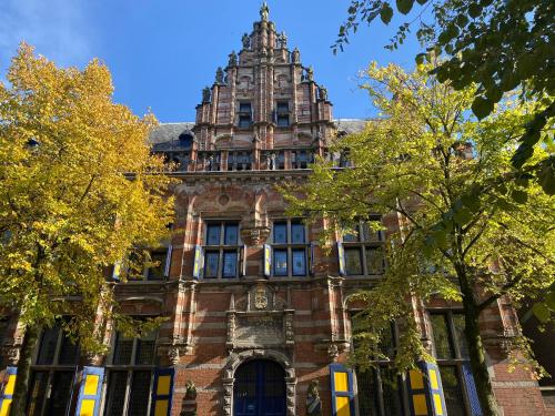 an old building with a tower on top of it at Vintage appartement in Pakhuis Friesland in centrum in Leeuwarden