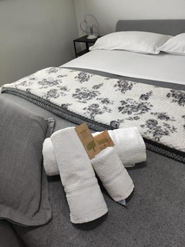 a bedroom with a bed with towels on the floor at Mamba House - 200 mt dal mare in Terracina