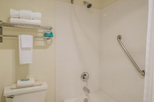 a bathroom with a shower and a toilet with towels at Best Western Alderwood in Lynnwood