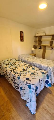 a bedroom with two beds in a room at Criollo Restó & Cabañas in Trevelin
