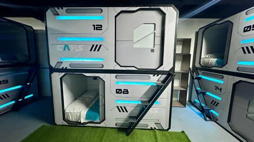 a room with two bunk beds with blue lights at Hotel Capsulas Quito in Quito