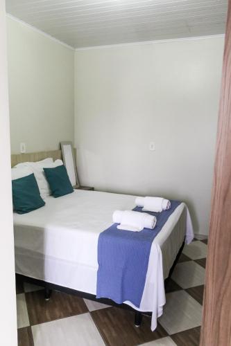 a bedroom with a large bed with towels on it at Eco Hotel in Navegantes