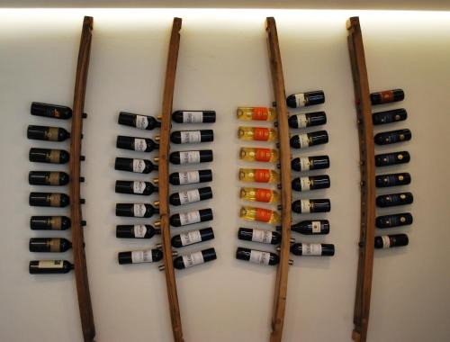 a wall of wine bottles in a wine cellar at OrtoPì Country Canapa House in Porto Recanati