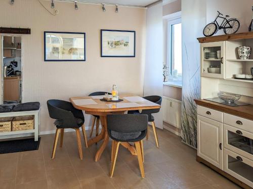 a kitchen with a wooden table and chairs at Comfortable holiday home in nature in Schönberg
