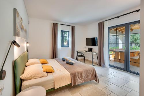 a bedroom with a bed and a desk in it at Villa Paronich in Barban