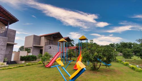 a playground with a slide in a park at THE PREMIER GIR RESORT in Sasan Gir
