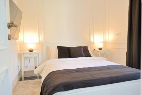 a bedroom with a large bed with two night stands at Vila Safra in Vrnjačka Banja