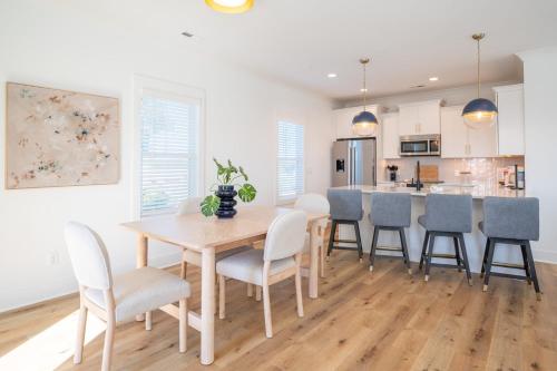 a kitchen and dining room with a table and chairs at Luxury Pet Friendly New Build - Go with the Flo 2 in Carolina Beach