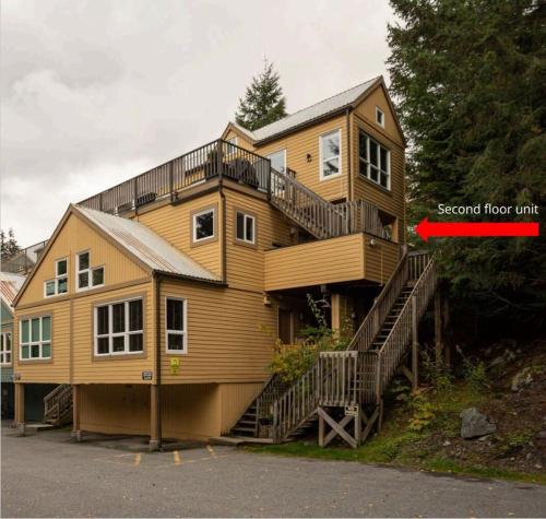 a large wooden house with a second floor unit at 1BR Condo, Close to Creekside Gondola by Harmony Whistler Vacations in Whistler