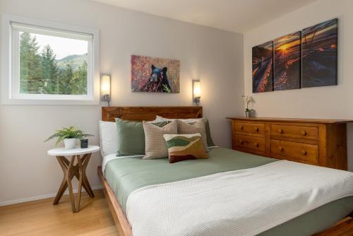 a bedroom with a large bed and a window at 1BR Condo, Close to Creekside Gondola by Harmony Whistler Vacations in Whistler