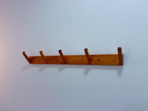 a wooden shelf hanging on a wall at Mathiveri Thundi Inn in Mathiveri