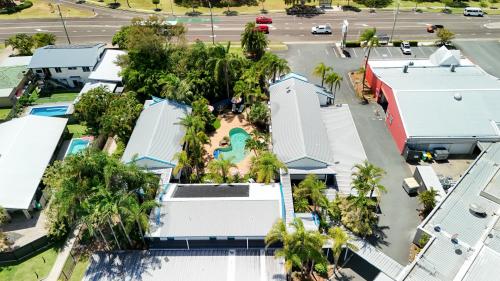 an aerial view of a resort with a pool and palm trees at Currimundi Hotel in Caloundra
