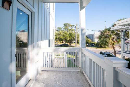 a balcony with a view of a street at Luxury New Build with Oceanview - Grow With The Flow in Carolina Beach
