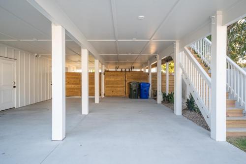 an empty hallway of a house with white columns at Luxury New Build with Oceanview - Go with the Flo 1 in Carolina Beach