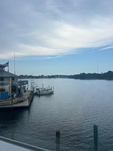 a dock with a boat in the water at The Moorings Hotel and Marina of Carrabelle in Davis Island