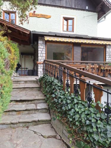 a house with a staircase leading to the front entrance at Appartement Bergliebe in Mauterndorf