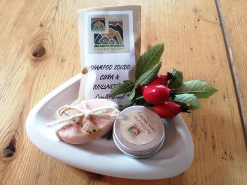 a plate of food with meat and vegetables on a table at Alpi Giulie Chalets in Valbruna