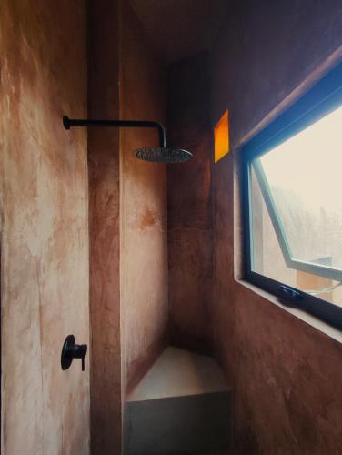 a shower in a bathroom with a window at Estudio Nacui in El Sargento