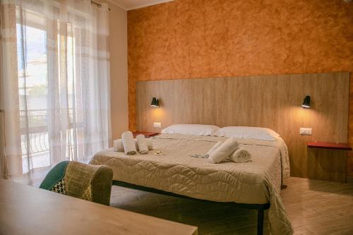a bedroom with a large bed with towels on it at MontagnaVivaCilento in Piaggine