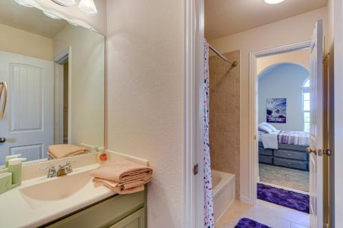a bathroom with a sink and a mirror and a shower at Pet-Friendly Leander Home with Fully Fenced Yard! in Leander