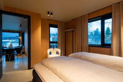 a bedroom with two beds and a table and chairs at Aurora Escape in Tromsø