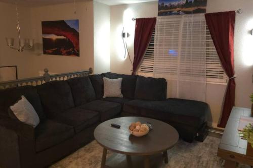 a living room with a couch and a table at Colorado Four Season Funhouse in Colorado Springs