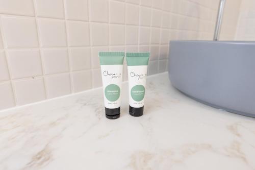 two bottles ofodorizers sitting on a counter in a bathroom at Currimundi Hotel in Caloundra