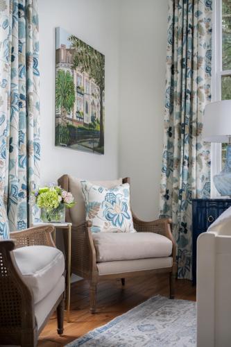 a living room with a chair and a table at Hamilton Turner Inn in Savannah