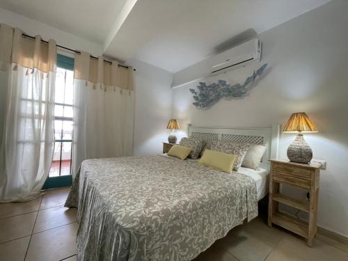 a bedroom with a bed and a window at PORT ROYAL APARTMENTS, Heated pool, Speed WiFi, Terrace in Arona