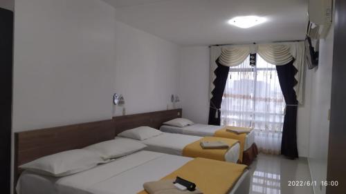 Postel nebo postele na pokoji v ubytování Hotel Quezada Hermanos
