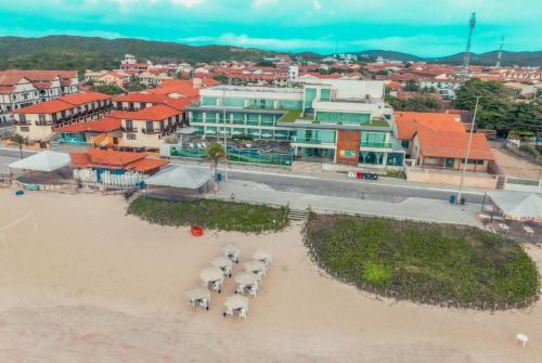 an aerial view of a town with a beach and buildings at Paradiso Peró Praia Hotel in Cabo Frio