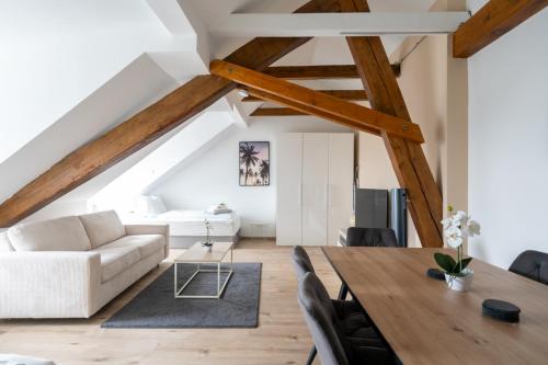 a living room with a table and a couch at COY Apartments Leoben - Stay Comfortable & Work Smart in Leoben