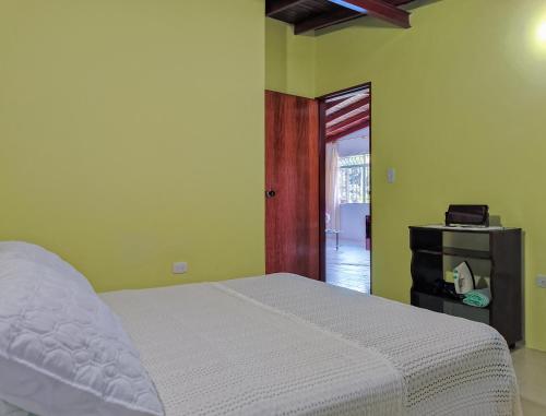 a bedroom with a bed and a door to a room at Casa Completa Concordia Andina Bien Ubicada Mérida in Mérida