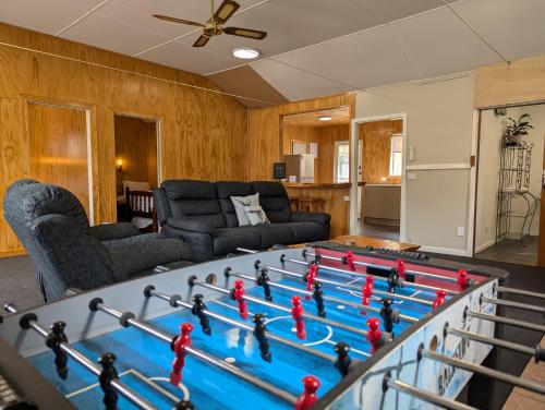 a living room with a large pool table with toy figures on it at Burkes Pass Country Motels in Burkes Pass